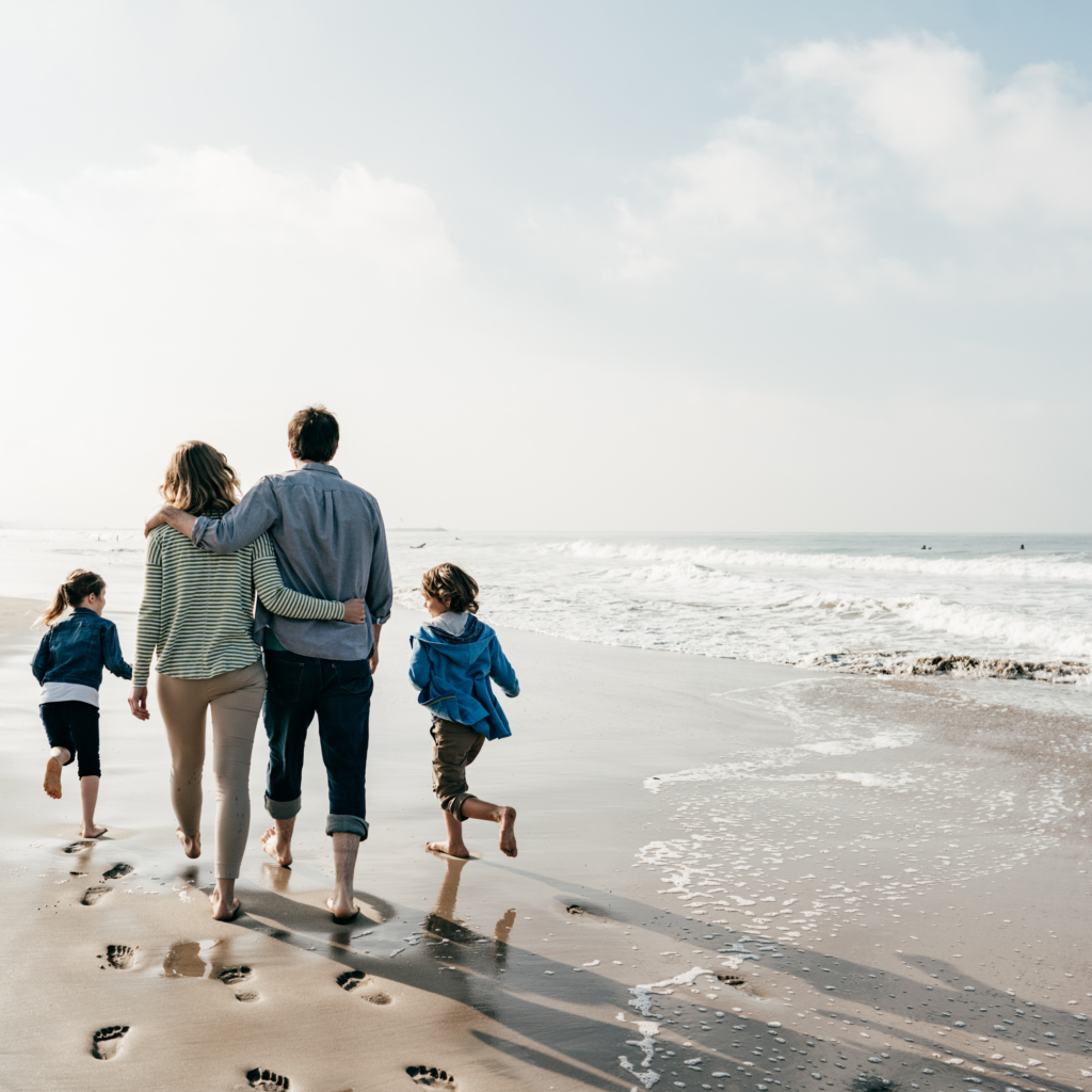 family of 4 on beach, running, happy