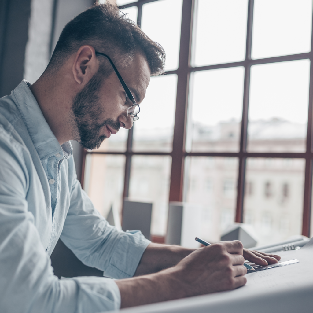 man planning drawing sketching journaling work professional