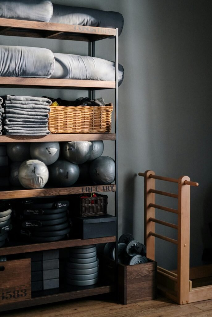 Neat arrangement of gym equipment and yoga mats in a modern fitness studio.