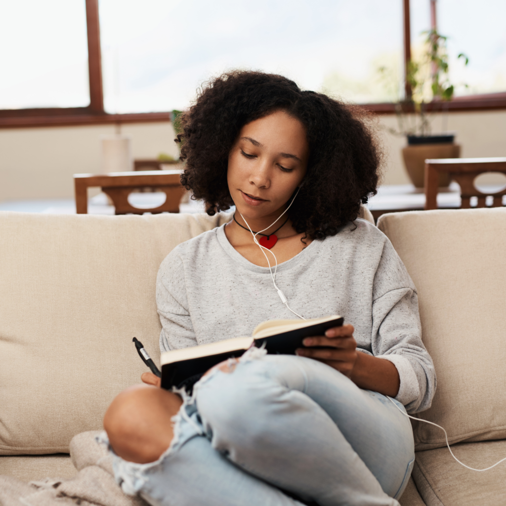 woman journaling planning on sofa reset